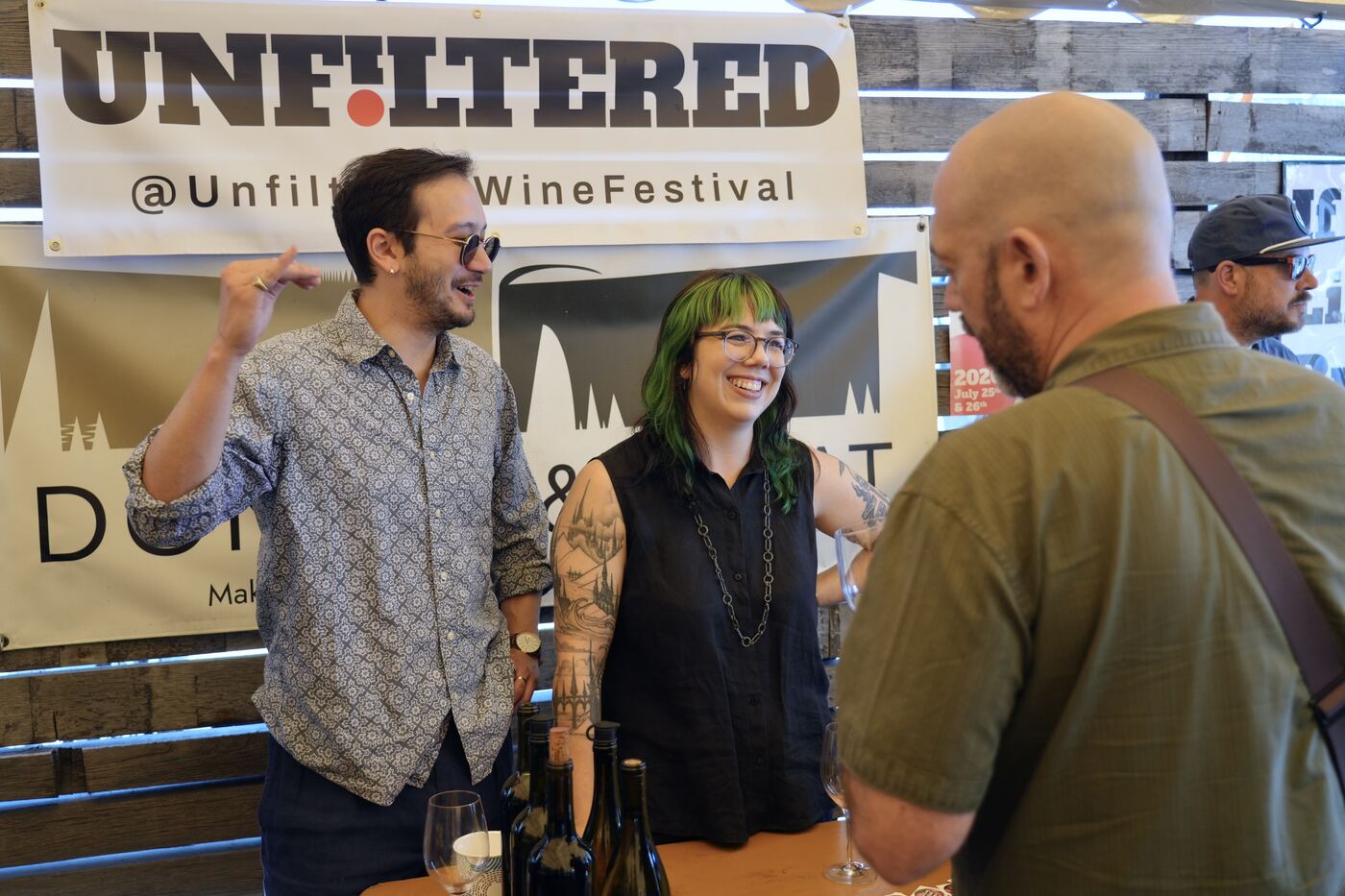 Winemakers and guests in front of the UNFILTERED banner