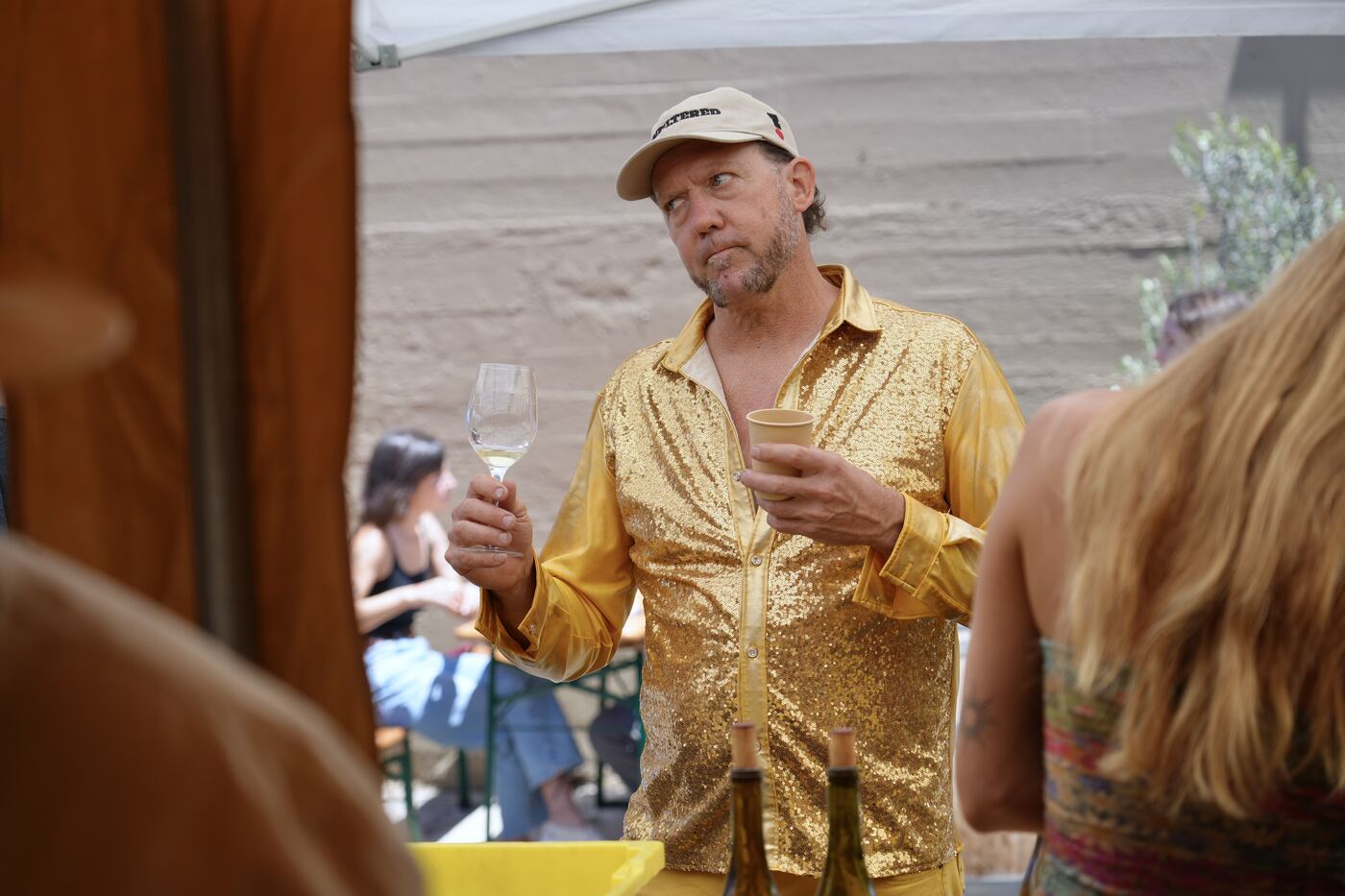 A guest in a gold sequined shirt